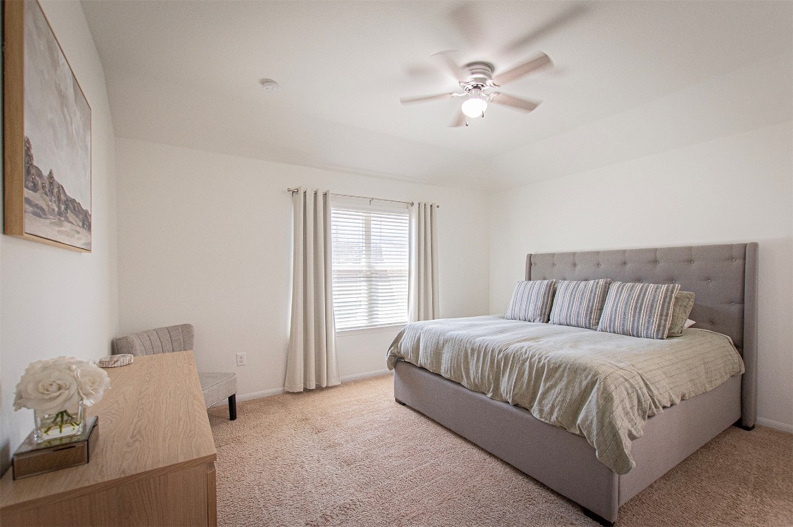 3513 Ortman Drive Pflugerville, TX 78660 - Photo 8 of 17 a spacious bedroom with a bed and window