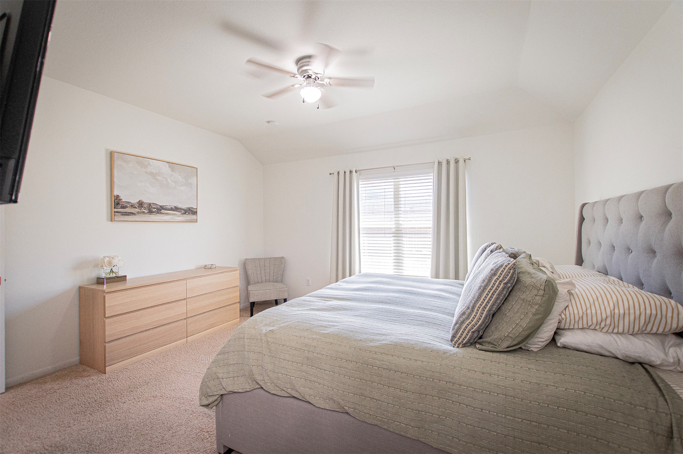 3513 Ortman Drive Pflugerville, TX 78660 - Photo 9 of 17 a bedroom with a bed and a chandelier
