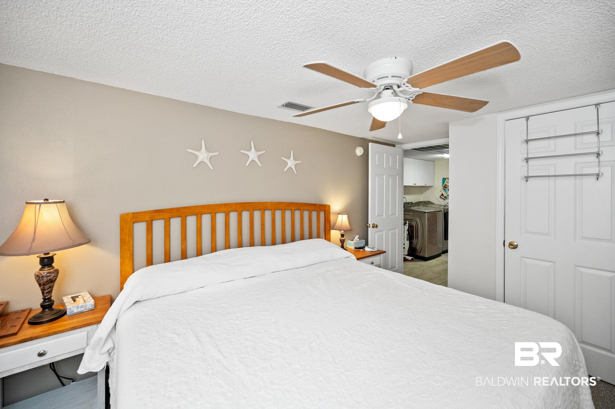 5392 Ornacor Avenue Orange Beach, AL 36561 - Photo 19 of 48 Carpeted bedroom with ceiling fan, a closet, a textured ceiling, and independent washer and dryer