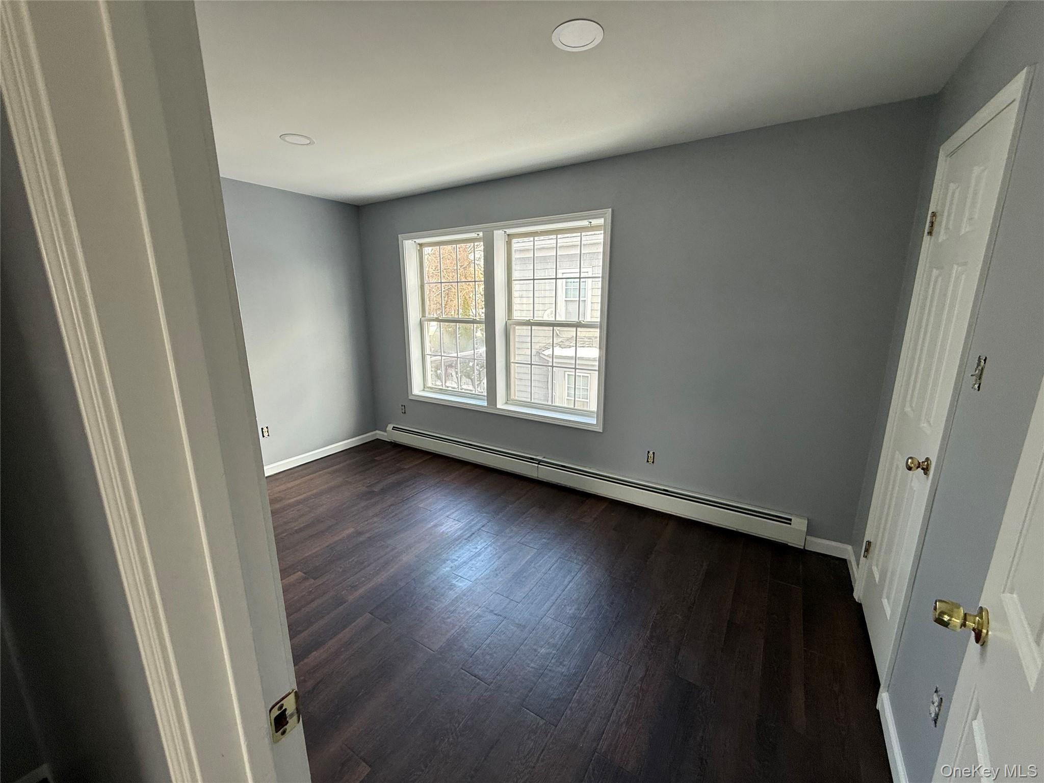 17 Orchard Place, Unit C Poughkeepsie, NY 12601 - Photo 11 of 20 an empty room with wooden floor and window