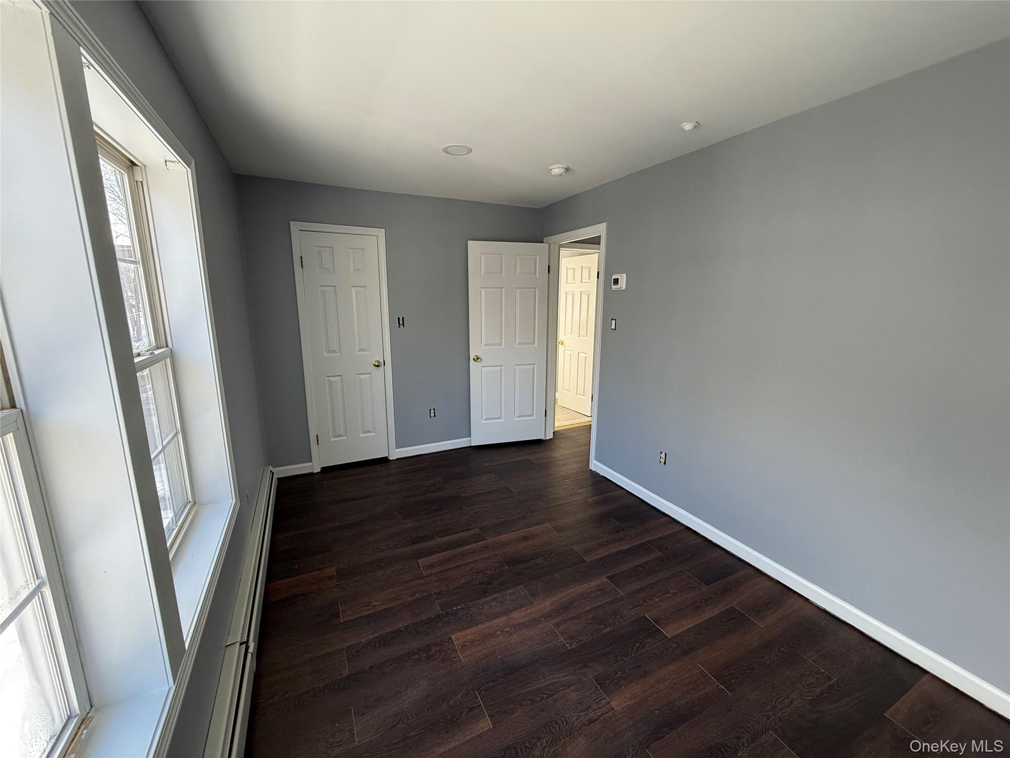 17 Orchard Place, Unit C Poughkeepsie, NY 12601 - Photo 12 of 20 an empty room with wooden floor and entrance