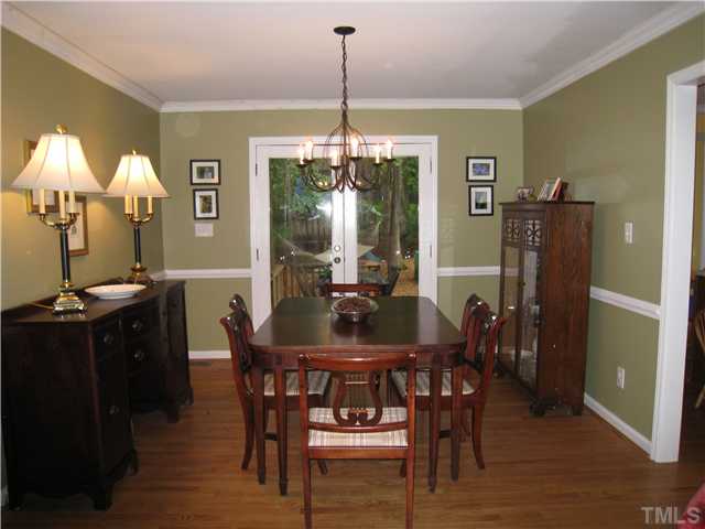 5709 Edgedale Drive Raleigh, NC 27612 - Photo 7 of 12 a view of a dining room with furniture and chandelier