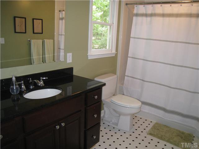 5709 Edgedale Drive Raleigh, NC 27612 - Photo 9 of 12 a bathroom with a sink a toilet a mirror and shower