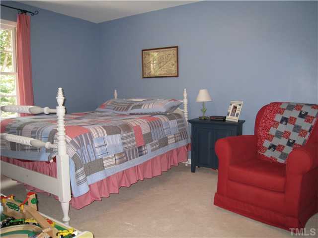 5709 Edgedale Drive Raleigh, NC 27612 - Photo 10 of 12 a bedroom with bed and a couch