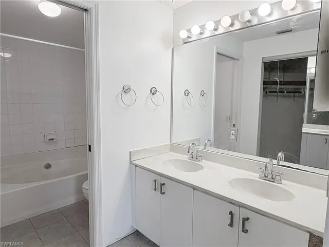 a bedroom with a bed and a mirror