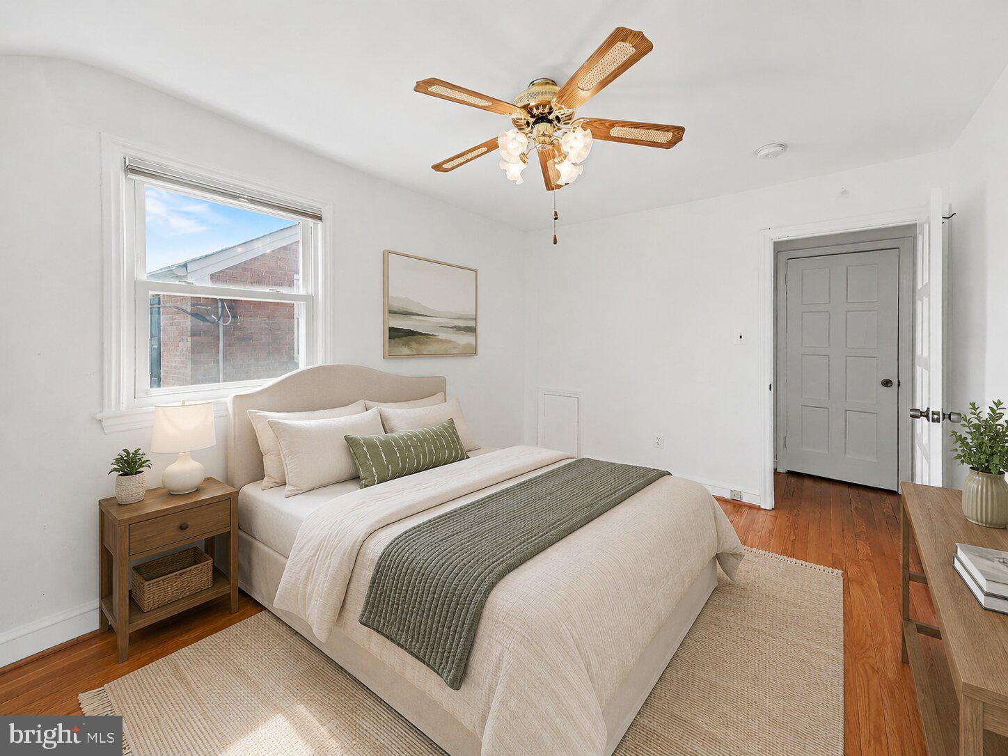 4504 20th Street Northeast Washington, DC 20018 - Photo 32 of 48 a bedroom with a bed and a chandelier