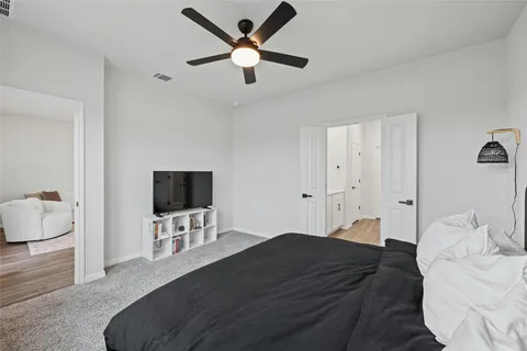 a bedroom with a bed and a flat screen tv