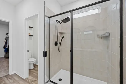 a bathroom with a glass shower door