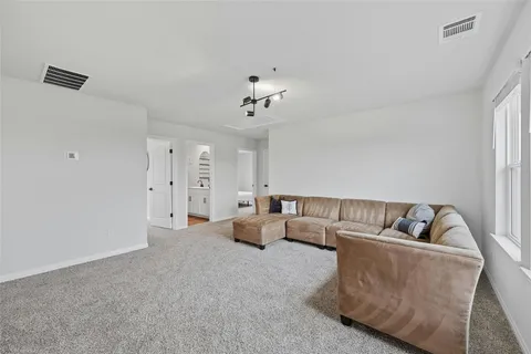a living room with furniture and white walls