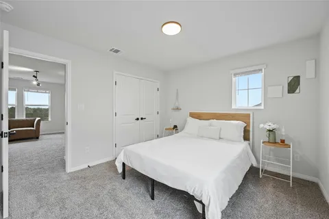 a bedroom with a bed and a mirror