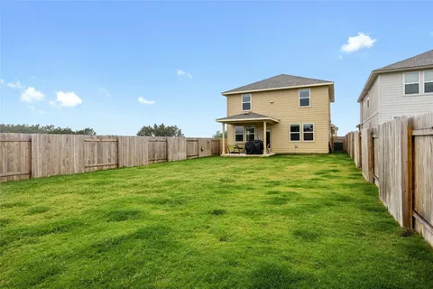 a view of a house with backyard and a garden