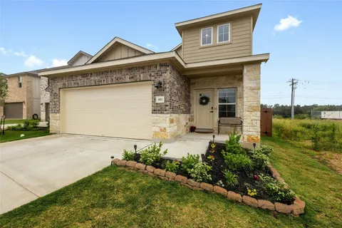 a front view of a house with garden