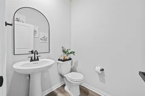 a bathroom with a sink toilet and a mirror