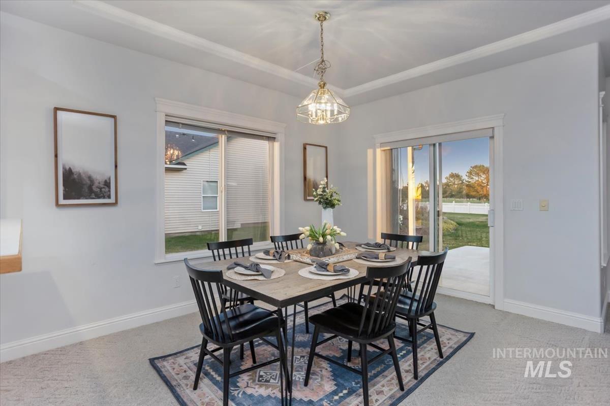 25074 The Driving Lane Caldwell, ID 83607 - Photo 5 of 29 Dining area with light colored carpet and baseboards