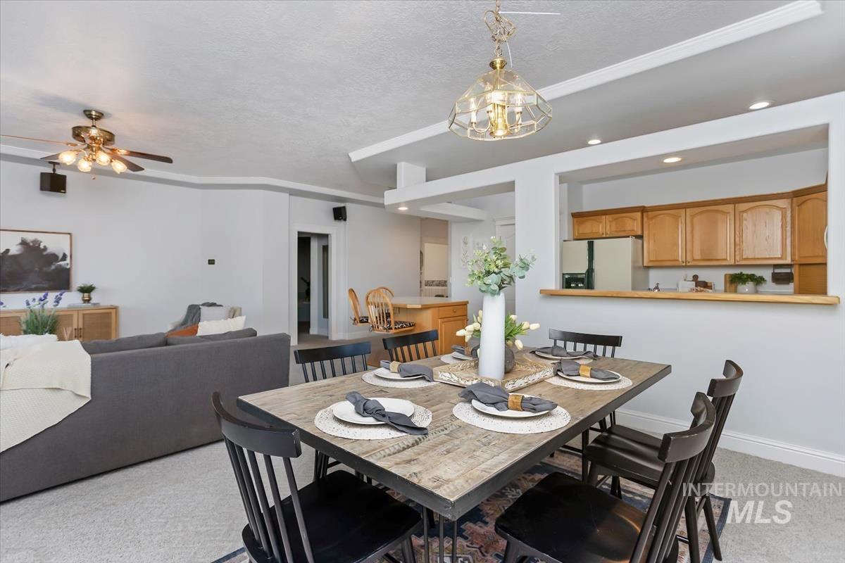25074 The Driving Lane Caldwell, ID 83607 - Photo 6 of 29 Dining room featuring light carpet, recessed lighting, a textured ceiling, and a ceiling fan