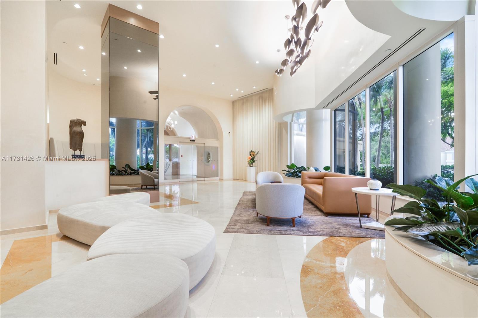 19355 Turnberry Way, Unit 19F Aventura, FL 33180 - Photo 1 of 18 a living room with furniture and large windows