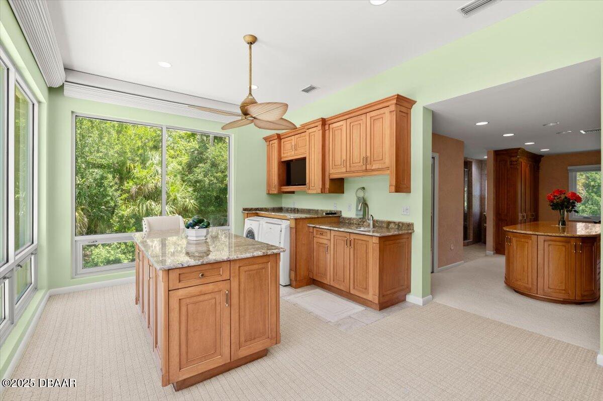 1010 Big Tree Road Daytona Beach, FL 32119 - Photo 2 of 41 a kitchen with kitchen island granite countertop a stove a sink a refrigerator and a counter top space