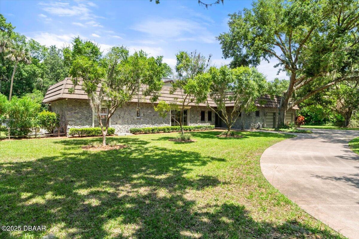 1010 Big Tree Road Daytona Beach, FL 32119 - Photo 30 of 41 a view of a swimming pool with a garden