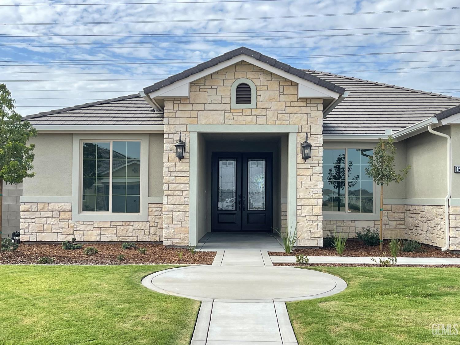 Undisclosed Address Bakersfield, CA 93314 - Photo 2 of 9 a front view of a house with garden