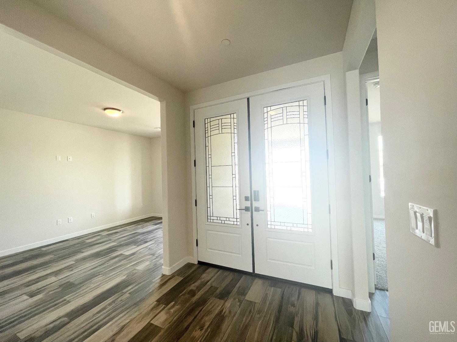 Undisclosed Address Bakersfield, CA 93314 - Photo 4 of 9 an empty room with wooden floor and windows