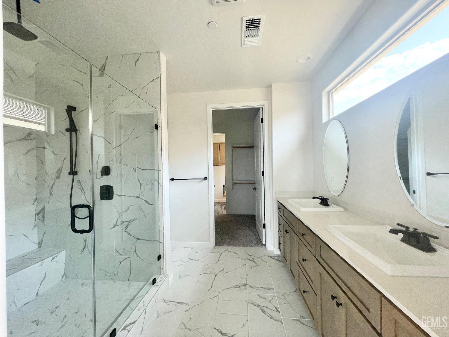 Undisclosed Address Bakersfield, CA 93314 - Photo 6 of 9 a spacious bathroom with a sink mirror and shower