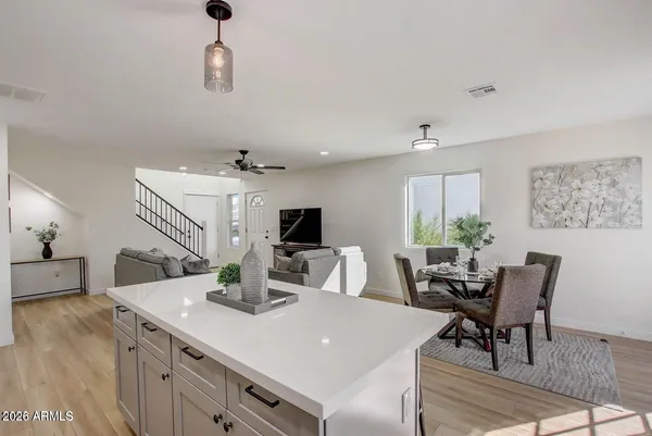 a kitchen with a sink a stove and chairs
