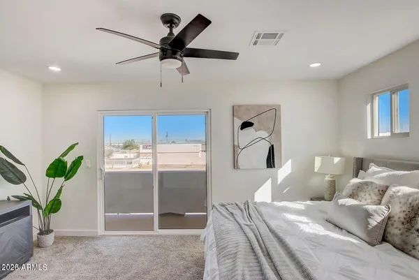 a bedroom with a large bed and a chandelier