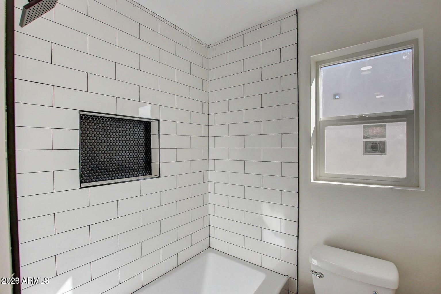 2509 East Broadway Road, Unit 2 Phoenix, AZ 85040 - Photo 33 of 47 a bathroom with a shower and a toilet