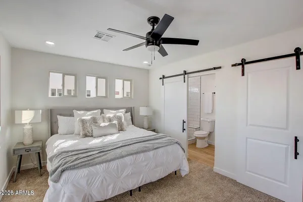 a bedroom with a bed and a ceiling fan