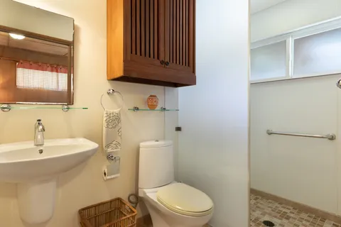 a bathroom with a toilet a sink and mirror