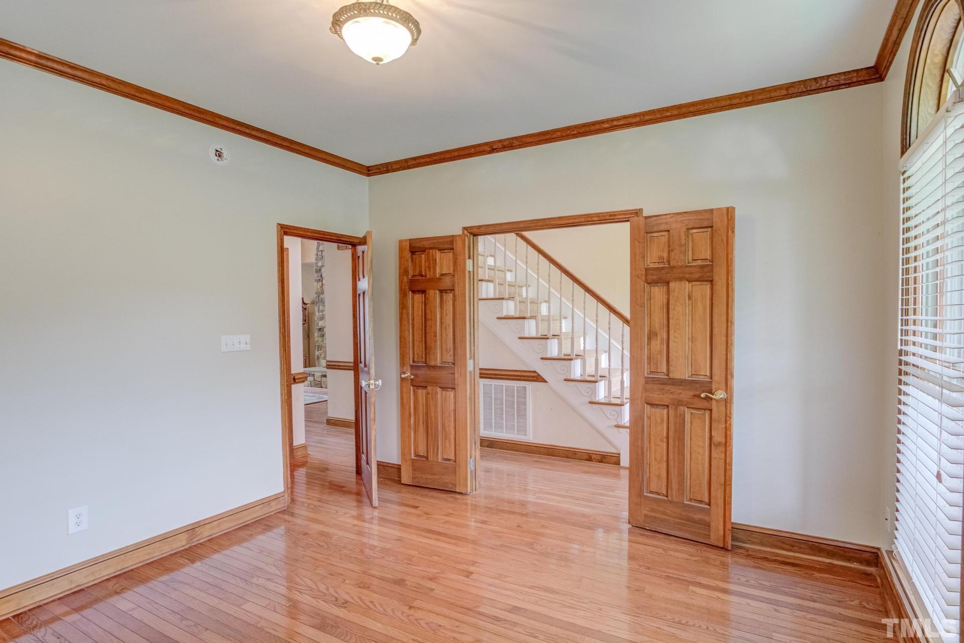 2213 East Garner Road Raleigh, NC 27610 - Photo 15 of 74 a view of empty room with wooden floor and fan