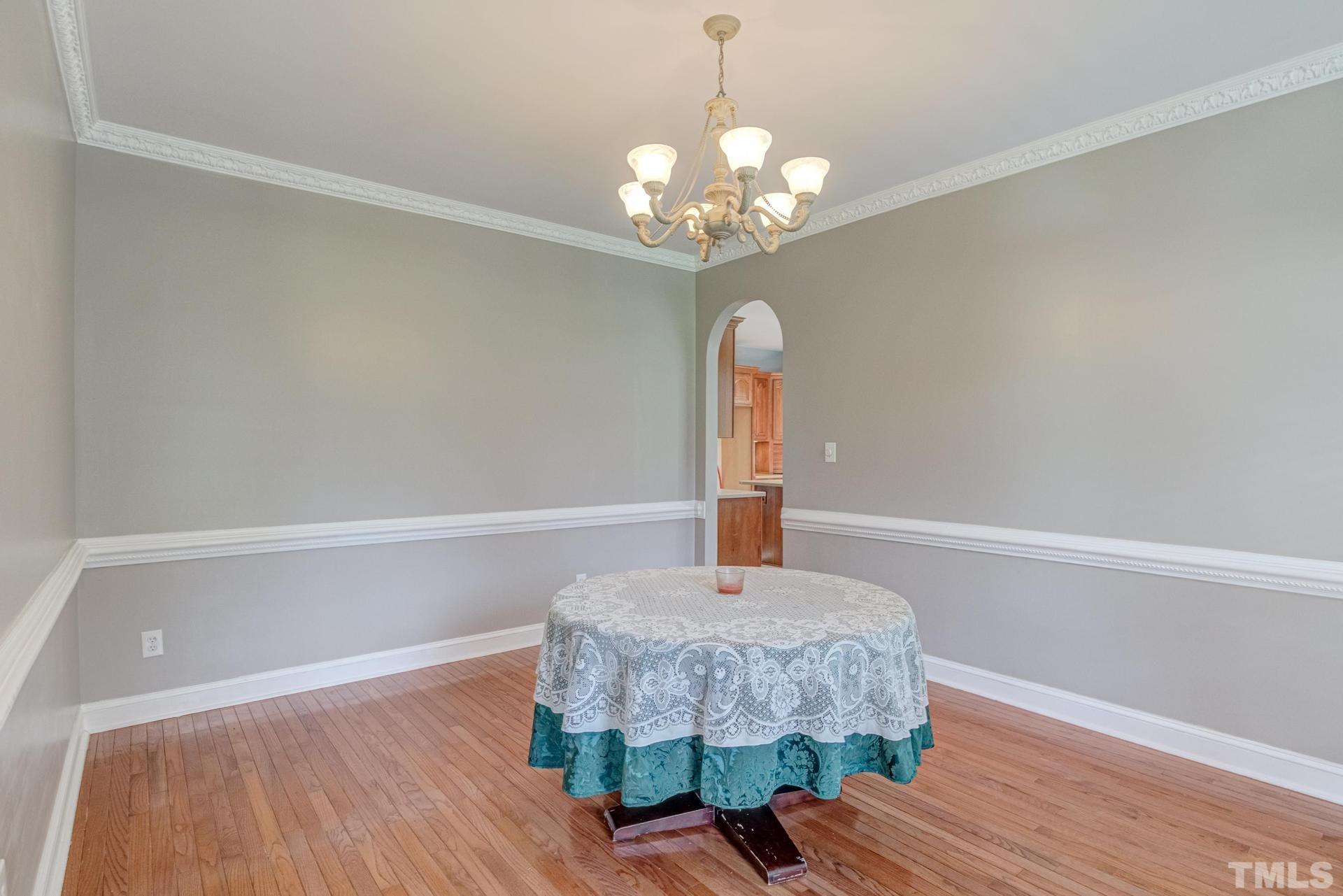 2213 East Garner Road Raleigh, NC 27610 - Photo 19 of 74 a room with a table and chandelier
