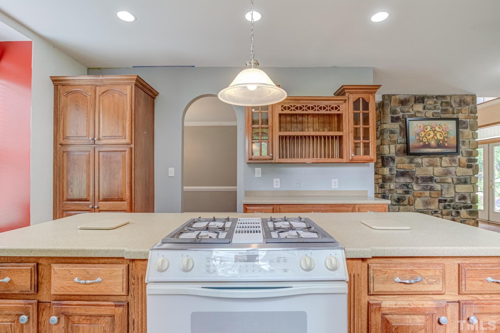 2213 East Garner Road Raleigh, NC 27610 - Photo 32 of 74 a kitchen with a stove and cabinets