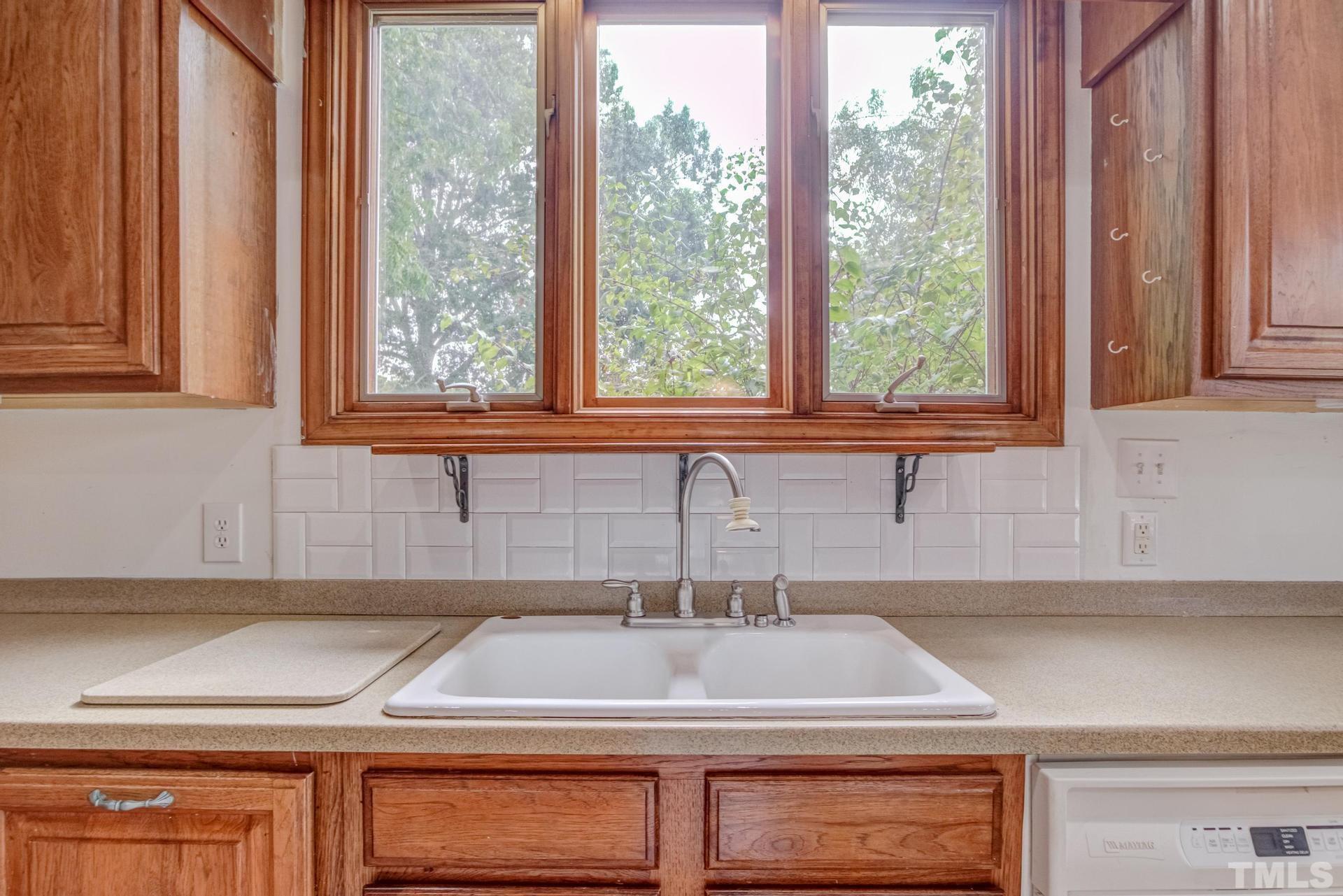2213 East Garner Road Raleigh, NC 27610 - Photo 33 of 74 a kitchen with a sink and a window