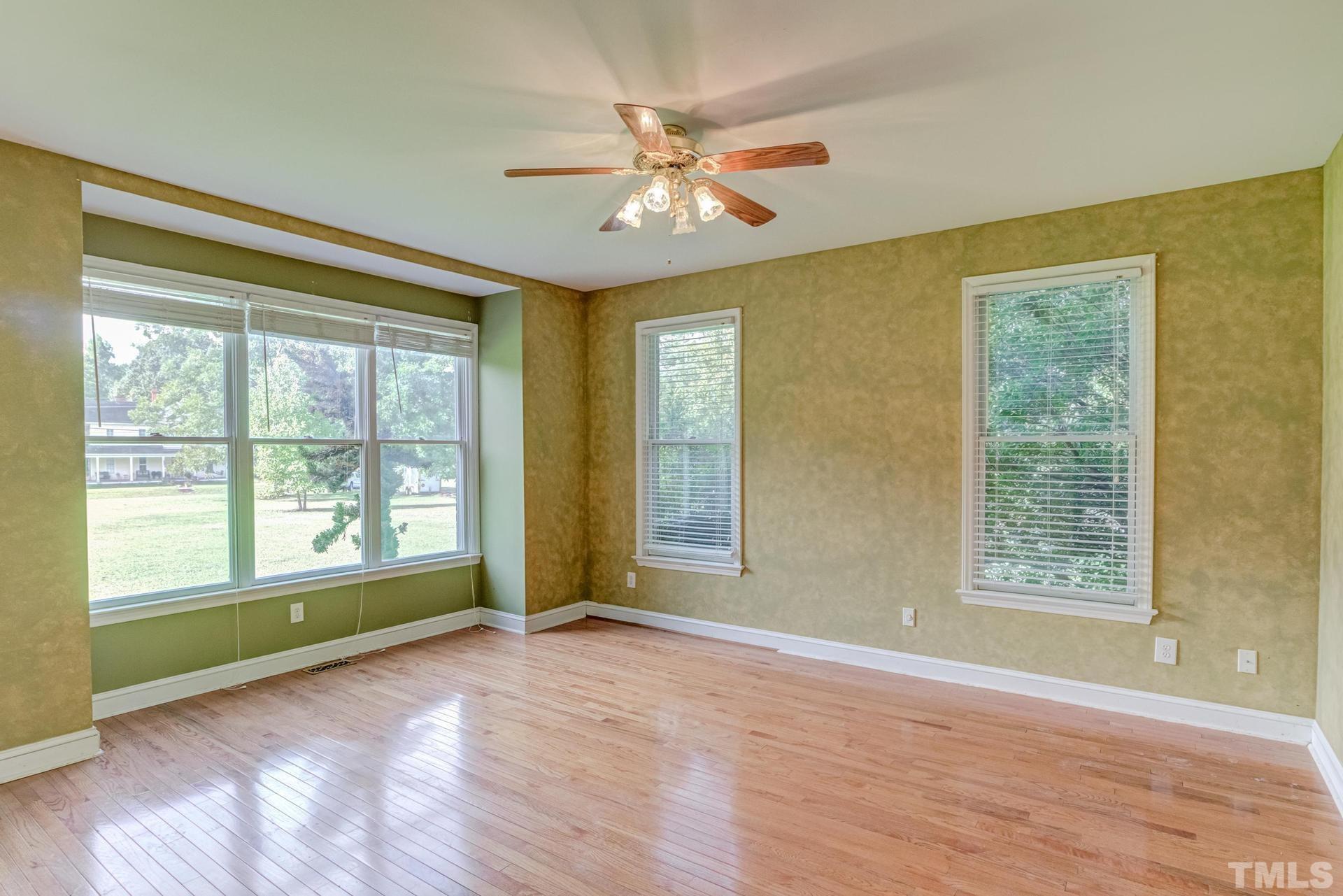 2213 East Garner Road Raleigh, NC 27610 - Photo 34 of 74 a view of an empty room with a window and wooden floor