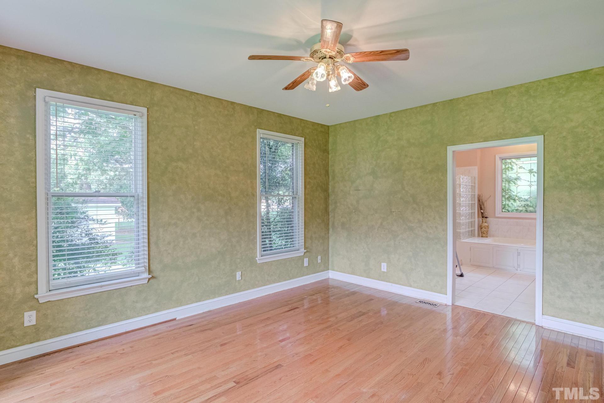 2213 East Garner Road Raleigh, NC 27610 - Photo 35 of 74 wooden floor in an empty room with a window
