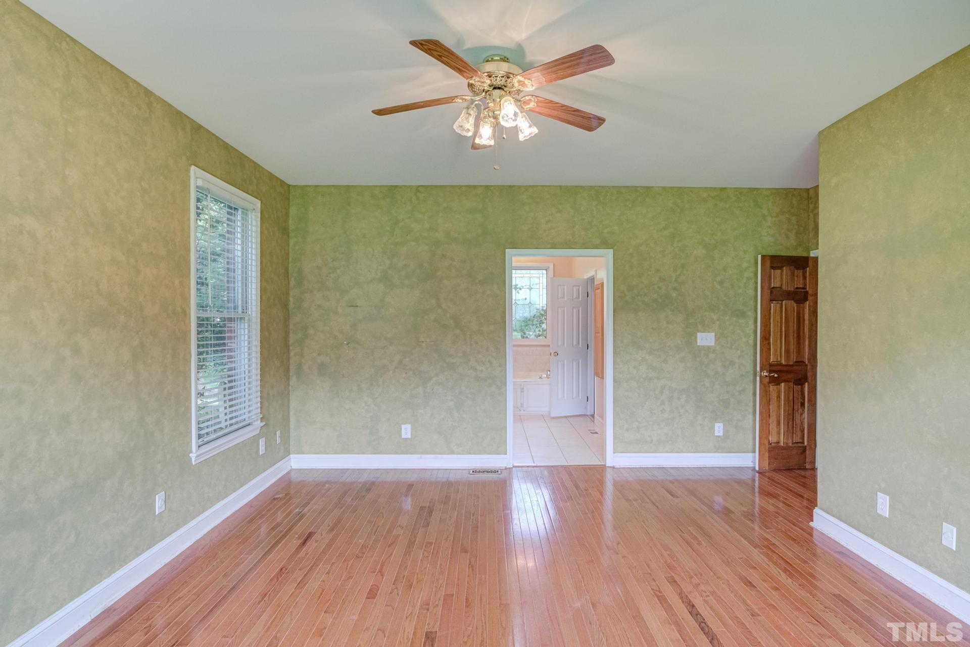 2213 East Garner Road Raleigh, NC 27610 - Photo 36 of 74 wooden floor in an empty room with a window