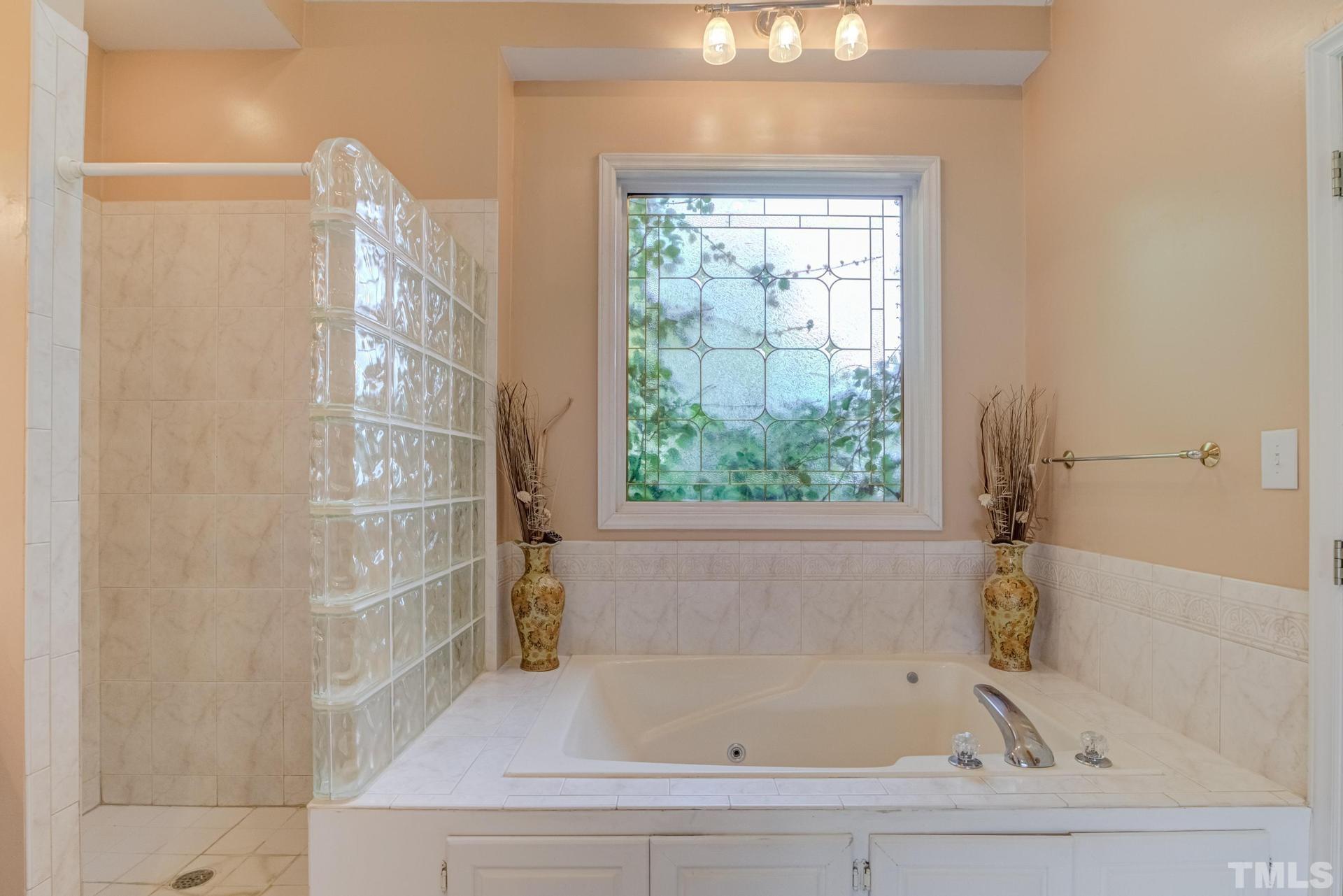 2213 East Garner Road Raleigh, NC 27610 - Photo 39 of 74 a bathroom with bathtub and window