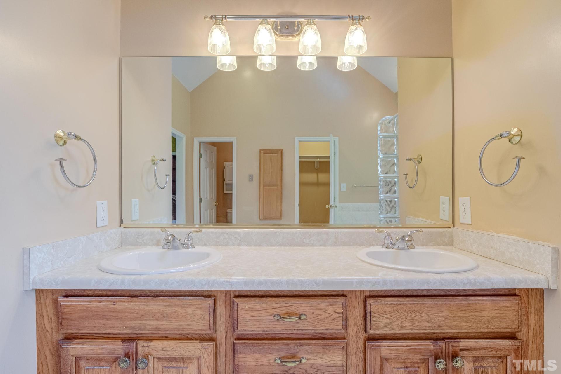2213 East Garner Road Raleigh, NC 27610 - Photo 40 of 74 a bathroom with a sink vanity and a mirror