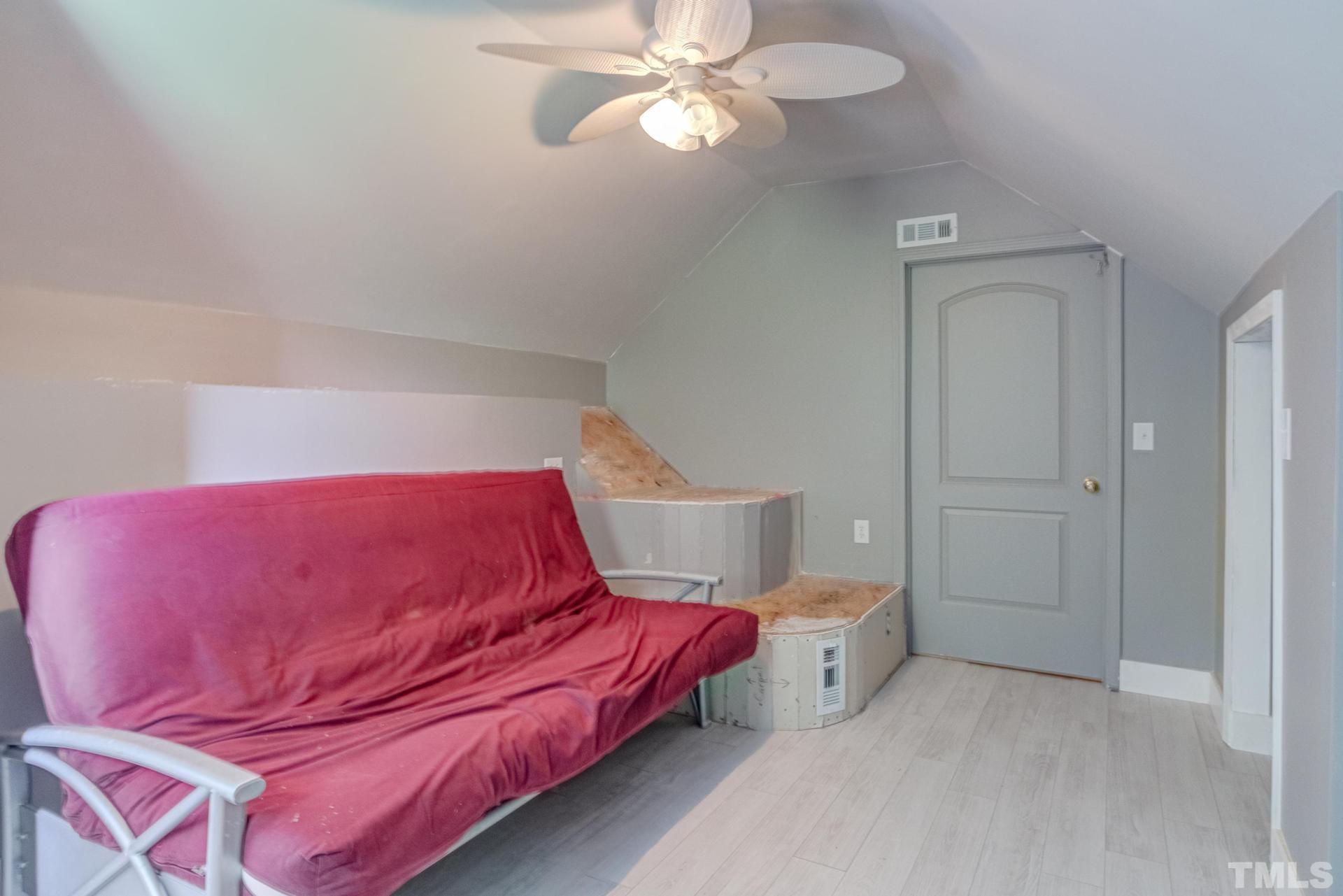 2213 East Garner Road Raleigh, NC 27610 - Photo 56 of 74 a bedroom with a bed and a chandelier