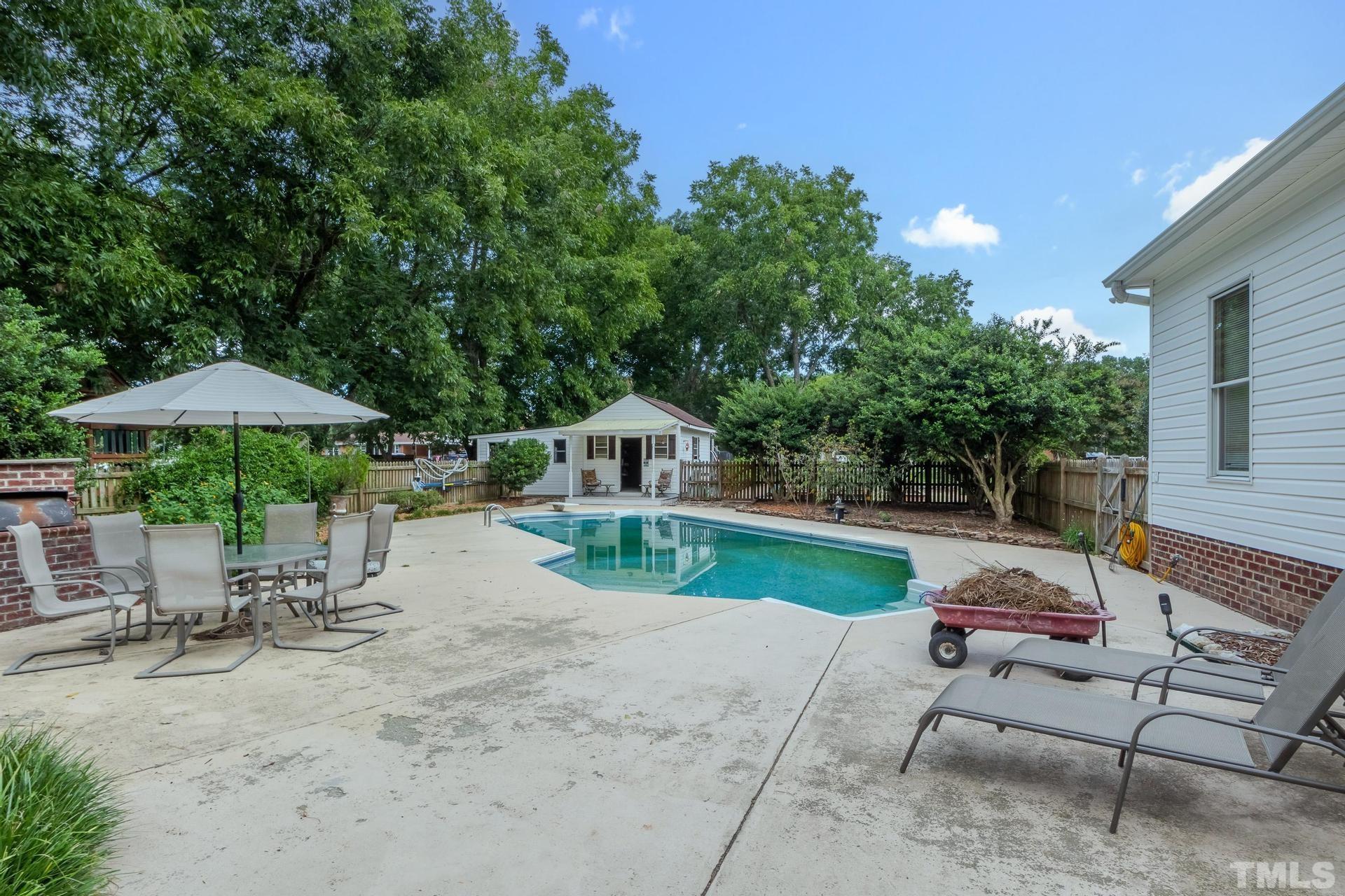 2213 East Garner Road Raleigh, NC 27610 - Photo 67 of 74 a view of backyard with table and chairs under an umbrella
