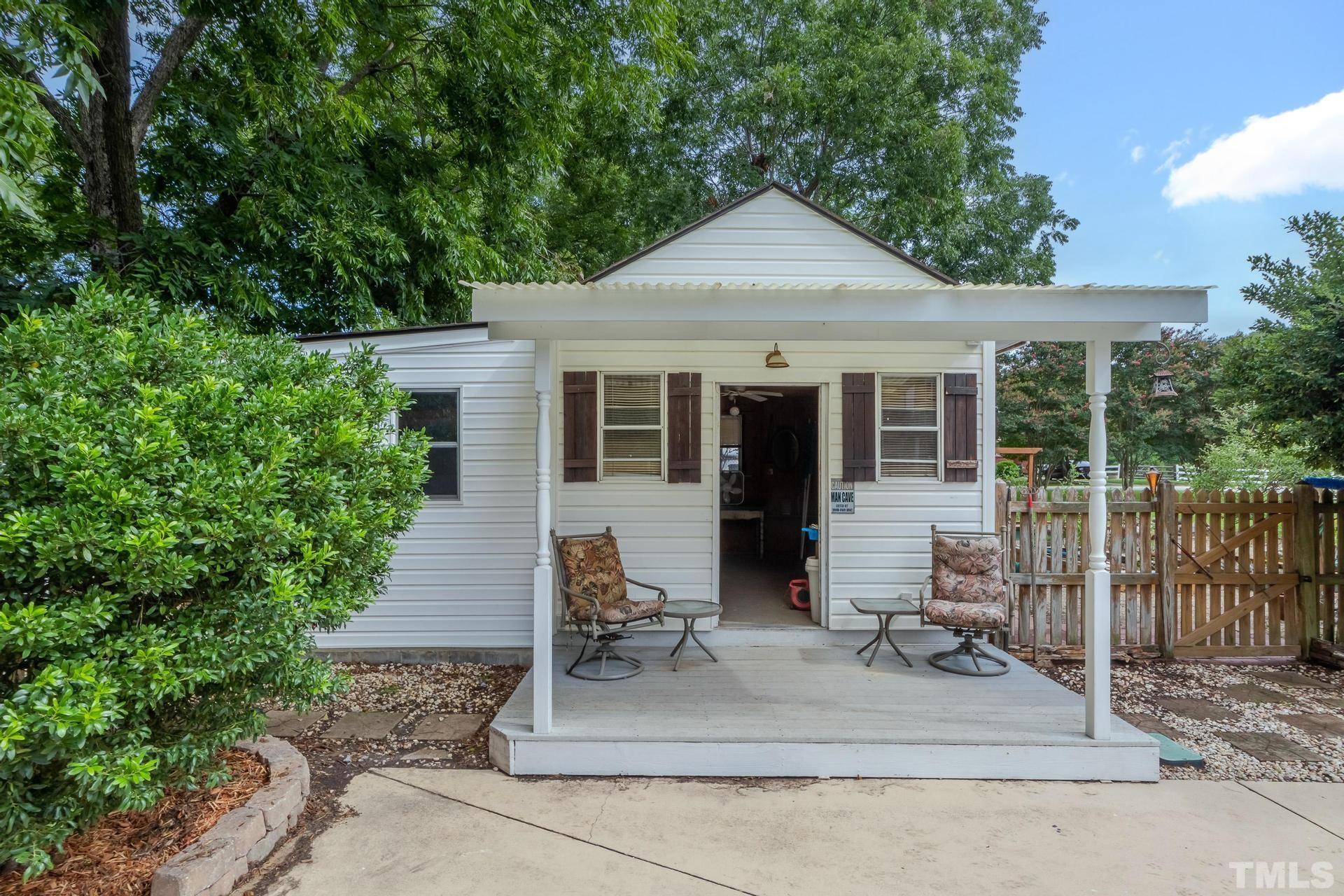 2213 East Garner Road Raleigh, NC 27610 - Photo 73 of 74 a front view of a house with a yard