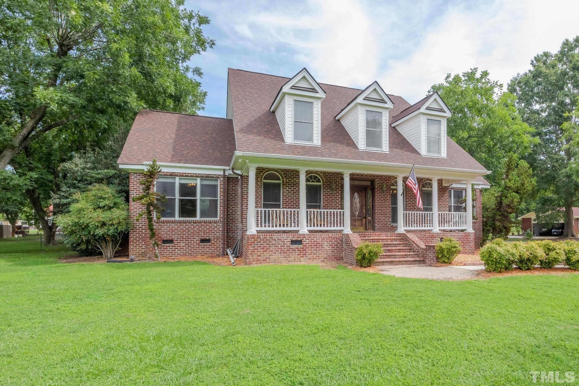 2213 East Garner Road Raleigh, NC 27610 - Photo 8 of 74 a front view of a house with a yard and garden