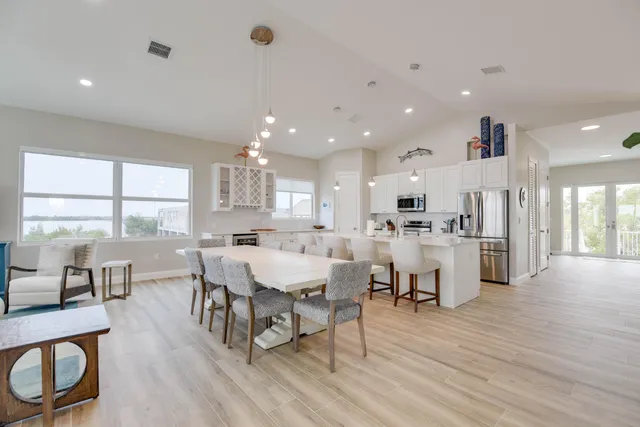 a bedroom with a large bed and wooden floor