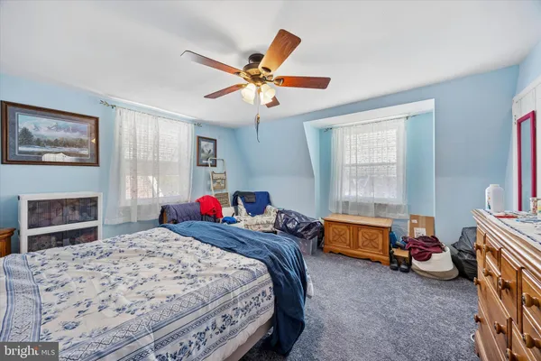 a bedroom with bed and a chandelier