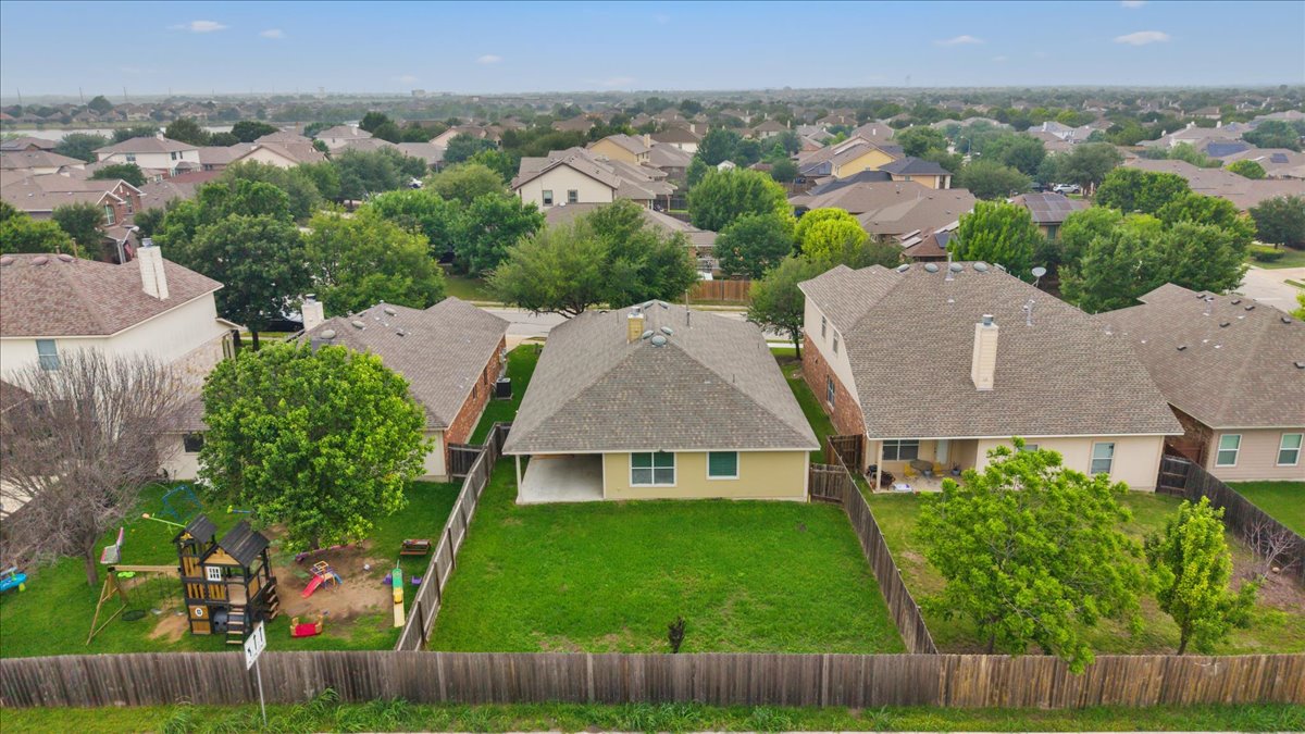 17812 Masi Loop Pflugerville, TX 78660 - Photo 35 of 38 Suburban neighborhood with mature trees and single-story residences