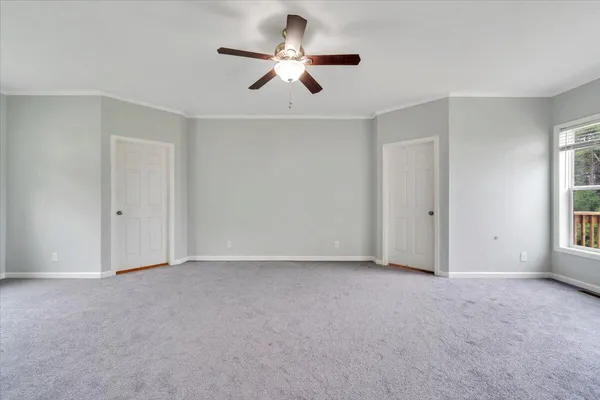 a living room with furniture and a baby crib