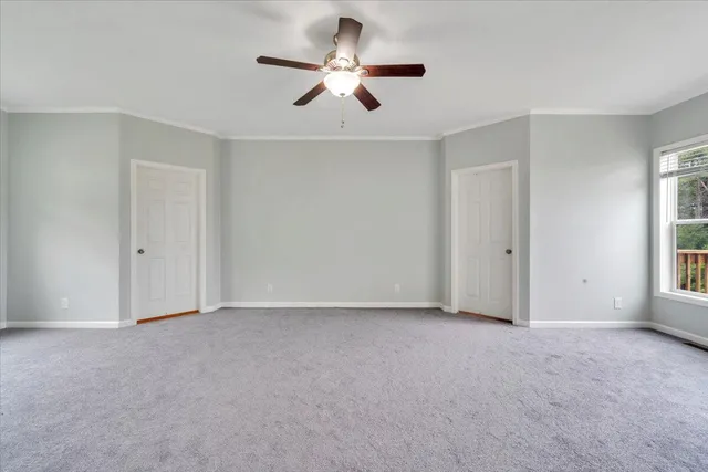 a living room with furniture and a baby crib