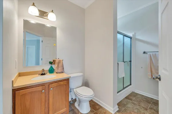 a bathroom with a sink mirror vanity and toilet