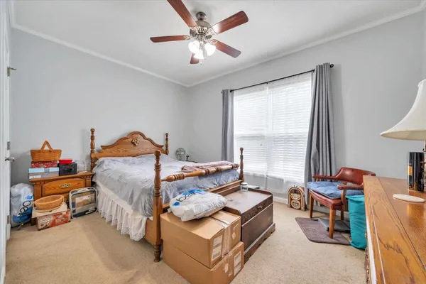 an empty room with windows and ceiling fan